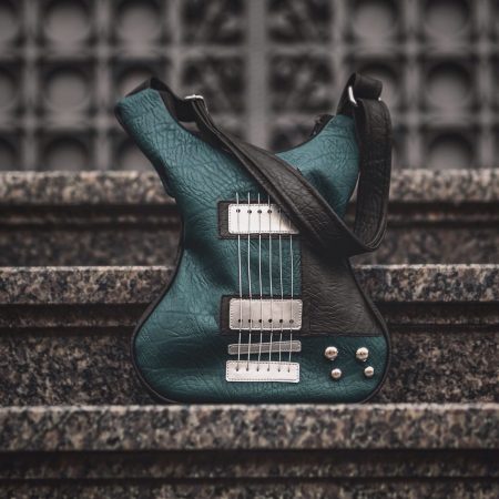 Handmade green leather guitar-shape crossbody bag with real strings.