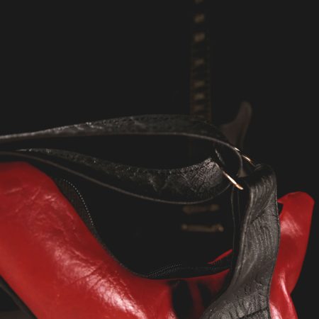 Red guitar bag in Italian eco leather with real guitar strings, a perfect rock-themed accessory from Bysolbags