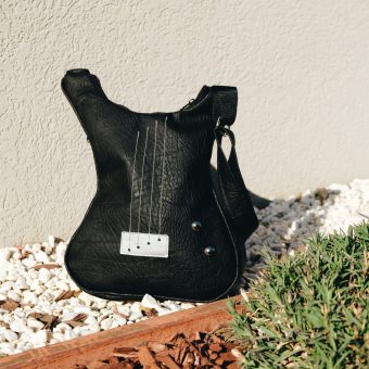 Minimal black guitar shaped bag.