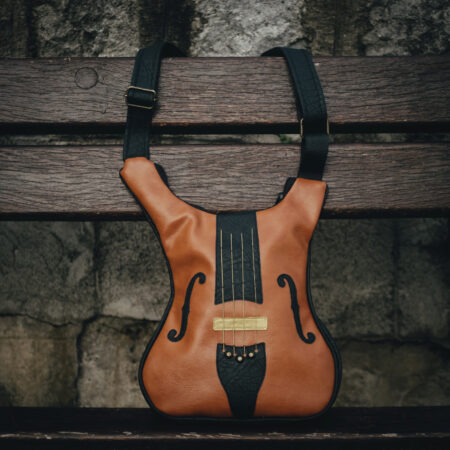 Brown violin shaped leather crossbody bag with strings attached